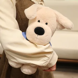 Adorable cream Labrador puppy plush toy dog, soft stuffed animal doll held in arms