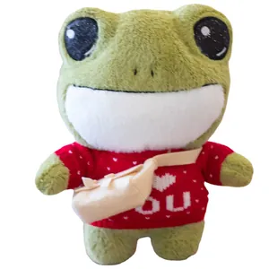 Cute green plush frog doll wearing a red knitted heart sweater and small crossbody bag