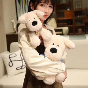 Cute cream Labrador plush puppy dog stuffed animal toy held by a model in a cozy home