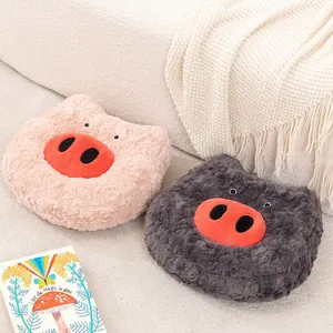 Cute and cozy pig nose plush cushions in pink and grey displayed on a soft white sofa