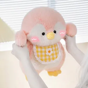Cute pink and white plush penguin toy wearing a yellow checkered bib, soft stuffed gift