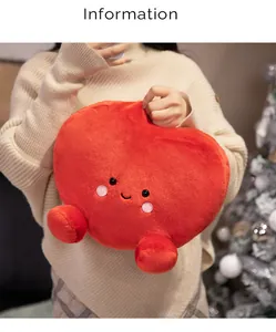Detail view of soft red heart-shaped plush toy pillow held by a model