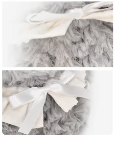 Macro view of plush gray faux fur texture with delicate white satin ribbon bow