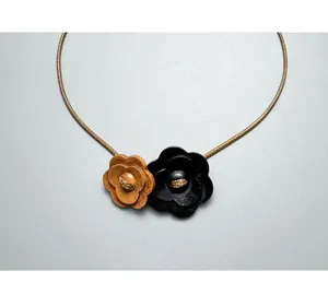 Close-up showing the intricate wood grain of flower pendants on the vintage choker