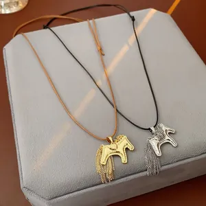 Detailansicht von Vintage Pferdeanhänger-Halsketten mit Metallquasten und Kordeln