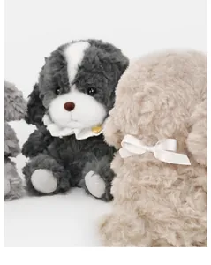 Close-up detail of fluffy puppy plush toys showing soft texture and ribbon bow.