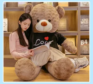 Detailed view of a giant plush teddy bear wearing a black t-shirt with 'Love' text