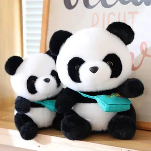 Pair of cute giant panda plush toys featuring green crossbody bags in a warm setting
