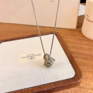 Detailed view of natural dalmatian jasper stone grape cluster pendant on silver chain