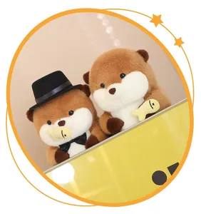 Detail shot of cute capybara and otter plush toys holding small yellow fish accessories