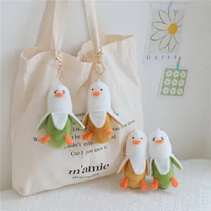 Close-up of adorable banana peel duck plush keychains displayed on a canvas bag