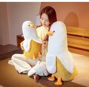 Creative banana duck plush toy held by a woman in a cozy lifestyle bedroom setting