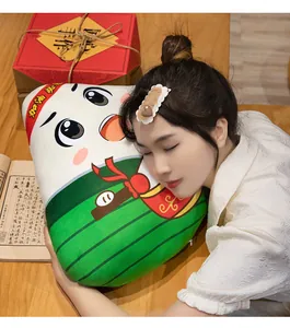 Close-up of a cute cartoon Zongzi plush pillow being used by a model in a cozy setting.