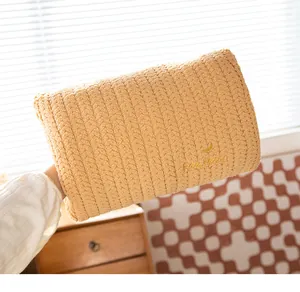 Detailed macro shot of a cozy yellow knitted hand warmer pillow with 'Fantasy' gold embroidery