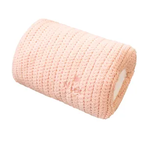 Soft pink knitted hand warmer pillow with embroidered heart and 'Nice' lettering