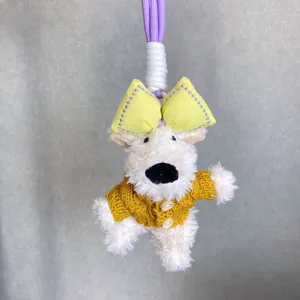 Adorable white plush Westie dog keychain featuring a yellow bow and knitted sweater