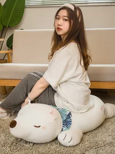 Cozy living room scene with a woman sitting on a long white polar bear plush pillow