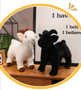 Detailed view of realistic white and black goat plush dolls on a wooden surface