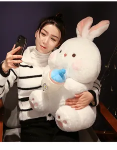 Soft plush white bunny stuffed animal with blue baby bottle accessory for children