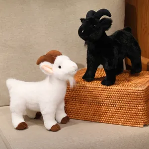 Realistic mountain goat plush toys, white and black set, displayed on a decorative wicker chest.