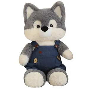 Adorable husky plush toy wearing blue denim overalls with HAPPY embroidery on white background