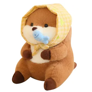 Adorable capybara plush toy wearing a yellow plaid hood and holding a blue fish prop