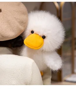 Close-up of fluffy white duck plush toy showing soft texture and cute orange beak