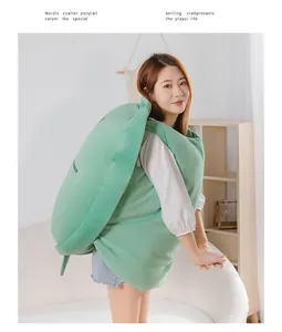Asian model wearing a giant green wearable turtle shell plush pillow
