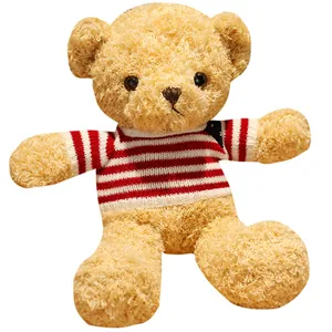 Adorable small teddy bear plush toy wearing a classic red and white striped sweater