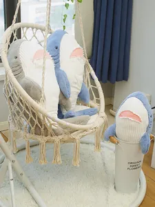 Cute blue and grey shark plush toys displayed in a cozy home interior setting