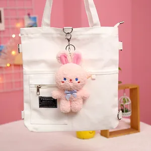 Cute pink plush bunny keychain accessory with blue bow for school bags and keys
