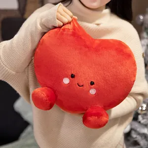 Soft red heart shaped plush pillow with cute smiling cartoon face expression