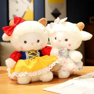 Pair of cute soft white sheep plush dolls wearing colorful dresses on wooden table
