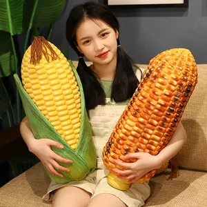 Realistic giant corn plush toy pillow showing raw and grilled corn designs held by a girl