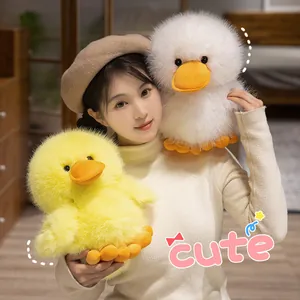 Fluffy yellow and white duck plushies held by a model in a cozy domestic scene