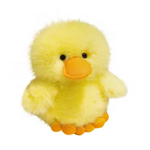 Cute soft fluffy yellow duck plush toy with big orange beak and frizzy fur on white background