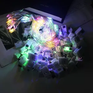 Colorful LED copper wire fairy lights detail showing vibrant rainbow glow and battery boxes
