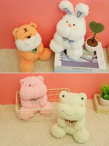 Group of soft plush toy animals including a white rabbit and orange tiger on a rug