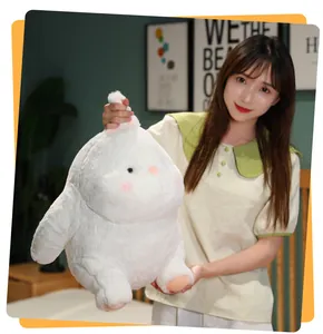 Close-up of a large soft white chubby pig plush toy held by a person in a cozy bedroom