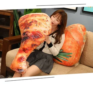 Asian model holding a large 3D realistic grilled chicken leg plush pillow on a sofa