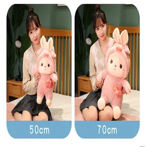 Cute pink rabbit plush doll in 50cm and 70cm sizes held by a model in a bedroom