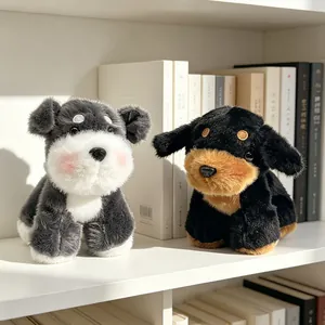 Two adorable simulation Schnauzer and Rottweiler plush dog toys on a white shelf.