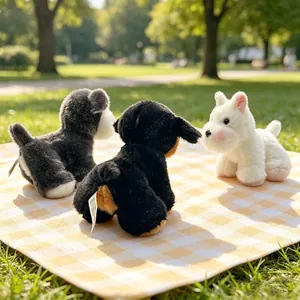 Three cute mini simulated plush puppy toys including Schnauzer and Westie on a sunny lawn