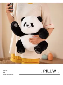 Cute giant panda plush toy held by a person, showing soft texture and realistic features.