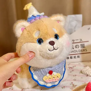 Adorable Shiba Inu plush toy with a colorful birthday hat and knitted bib decoration