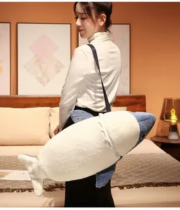 Life-sized shark plush long pillow with adjustable shoulder strap carried by model