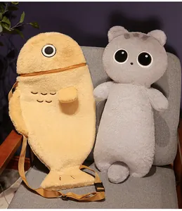 Cute plush cat long body pillow and yellow fish-shaped bag displayed on grey chair