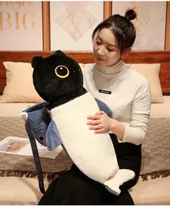 Close-up of a creative cat-shark hybrid long body plush toy held by a young woman