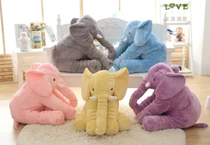 Detailed view of five colorful plush elephant toys in a cozy nursery setting.