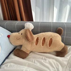 Adorable baguette bread dog plush doll wearing a white chef hat on cozy white bedding